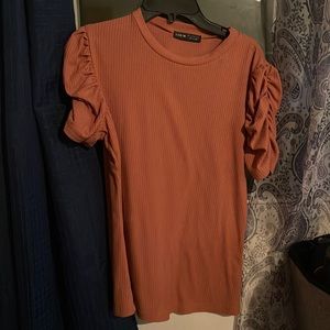 Caramel brown shirt kind of scrunched up from the shoulders